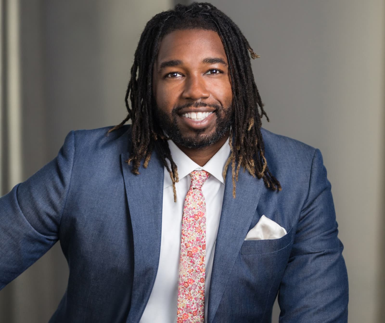 Corporate headshot photographed against a weathered timber door